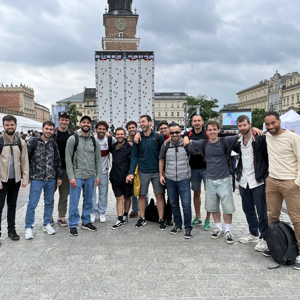 The group smiles on the main square in Kraków, with the Town Hall Tower behind them