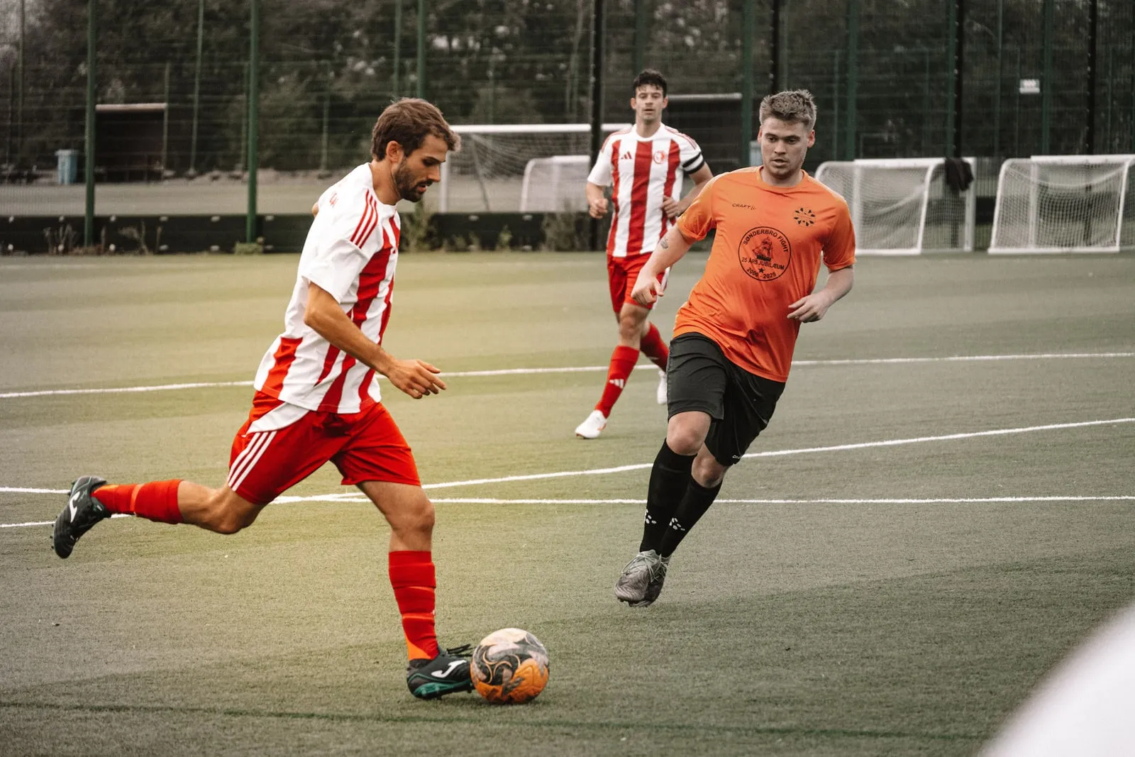 A player is about to strike the ball while an opponent closes in